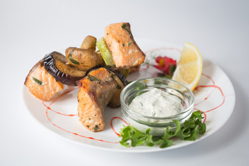 Grilled salmon and vegetables with lemon on the plate