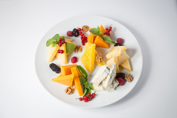 Lots of cheese with honey, grape, nuts, berries and mint