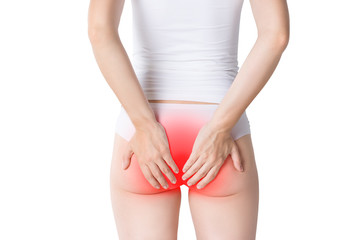 Woman suffering from hemorrhoids, anal pain on gray background