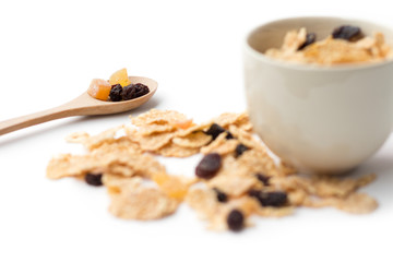 whole grain cereal flakes which mixed berry fruit and raisins for breakfast isolaed on white background