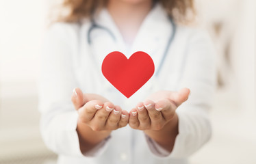 Cardiologist doctor holding virtual heart in hands