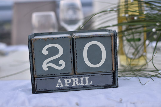 Wood blocks in box with date, day and month 20 April. Wooden blocks calendar
