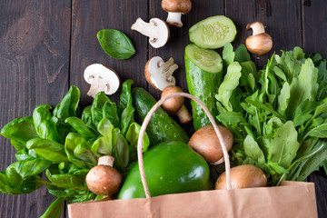 Close up of green vegetables on wooden background, flat lay