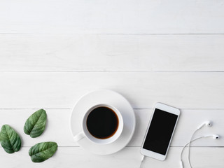 top view of office desk workspace with coffee cup, notebook, plastic plant, smartphone and keyboard on white background, graphic designer, Creative Designer concept.