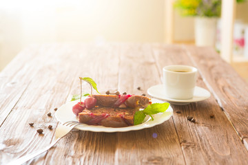 Slice of delicious homemade pie and cup of coffee on table