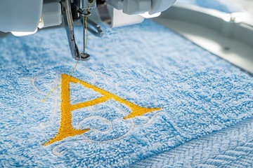 Embroidery machine and alphabet design on towel