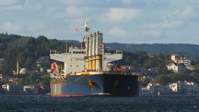 Blue cargo ship heading into Bosphorus Sea towards Istanbul. 1 Minute long Telephoto shot. Istanbul Strait is very narrow and winding shape of the strait route makes ships travelling. Shallow depth of