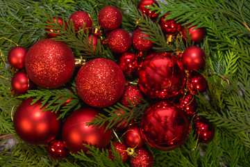 New Year's, Christmas red decorations and green coniferous branches on a gray background
