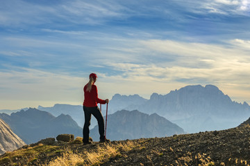 Obraz premium Sporty Young woman on mountain trail Dolomites Mountains, Italy