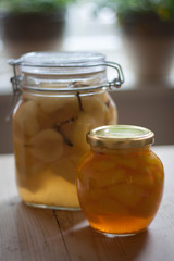 Preserved pears in glass jars, one with saffron