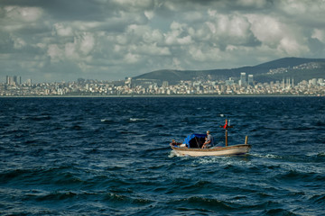 The small boat sails on the Bosphorus