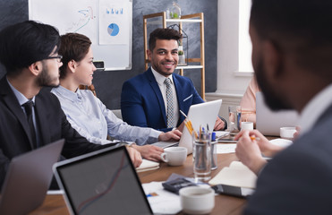 Multiracial business people discussing project at meeting