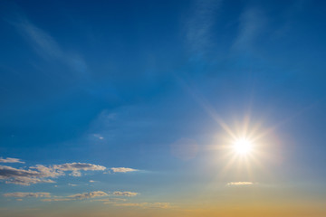 sparkle evening sun on a blue cloudy sky background