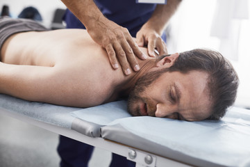 Massage therapy is one of most known ways to relieve tension. Doctor massaging cervical spine