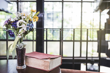 old book and vase on table