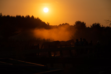 silhouette of horses and people 