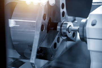 The CNC  grinder machine grinding inside the metal ring.Modern manufacturing process.