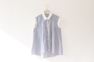 Natural colour blue clothes is clothes hanger on white background.