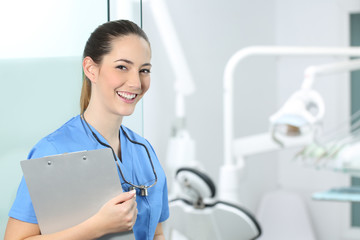 Happy dentst posing in a dental clinic