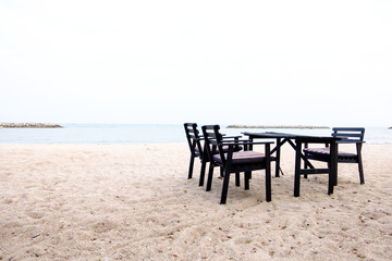 Fototapeta na wymiar Dining table and chairs on the beach