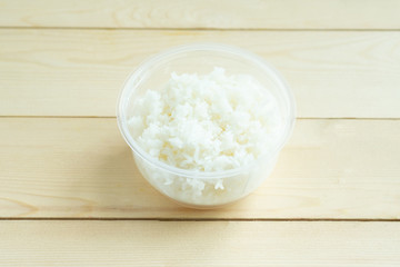 Cooked rice in plastic bowl