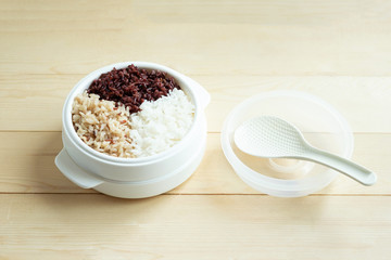 Mix of cooked rice in plastic bowl