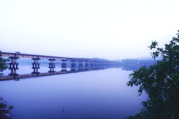 Railway bridge over river in the early morning 