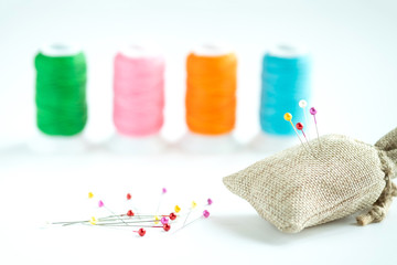 Clolorful sewing pins on white background