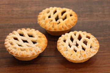 Christmas mince pies on a wooden background
