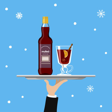 Bottle of mulled wine and glass on tray on blue background