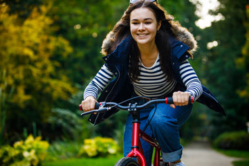 Urban biking - woman riding bike in city park