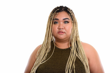 Studio shot of young fat Asian woman