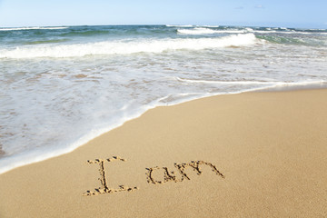 word written in sand on the beach