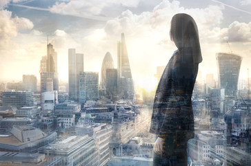 Young woman looking over the City of London at the early morning time. Future, new business opportunity and business success concept. - obrazy, fototapety, plakaty