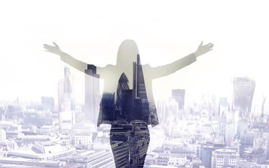 Young woman looking over the City of London at the early morning time. Future, new business opportunity and business success concept.