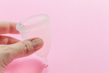 Obraz na płótnie Canvas Menstrual cup on pink background, feminine hygiene