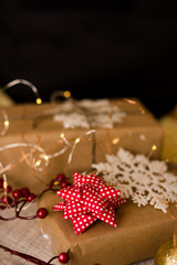 Fototapeta na wymiar Christmas gift or present box wrapped in kraft paper with decoration on rustic wooden background.
