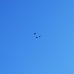 Naklejka na ściany i meble Fighter in the sky. Three planes in the sky. The parade of aircraft.