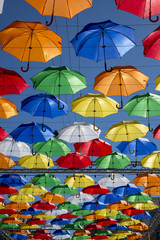 Fototapeta na wymiar Alley of soaring umbrellas in Solyany Lane in St. Petersburg