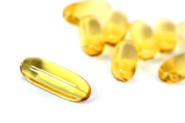 Close up yellow Cod Liver Oil capsule on white background, fish oil is a dietary supplement derived from liver of cod fish, have omega-3 fatty acids, EPA, DHA, vitamin A and D