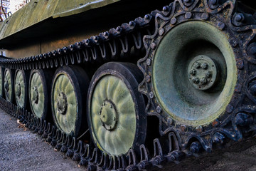 black caterpillar of an old military tank standing in victory park