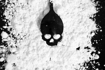 Black skull on a background of powdered sugar. Sugar kills. Sugar is dangerous to health. Also...