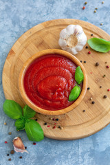 Wooden bowl with spicy tomato sauce.