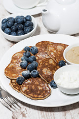 pancakes with peanut butter and yoghurt on white background, vertical