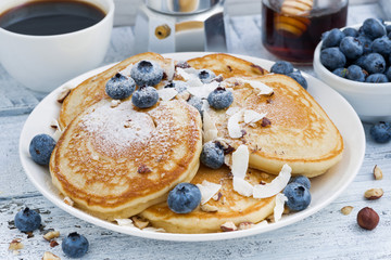 pancakes with fresh blueberries and honey for breakfast, closeup