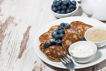 pancakes with peanut butter and yoghurt on white background