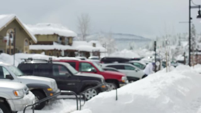 Busy snowy city street with a crowded parking lot for background plate 