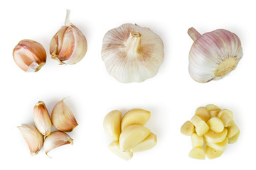 Set of whole garlic, halves, peeled slices on a white. The view from the top.