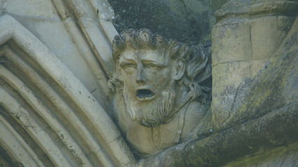 Corbel Head on The West Front of Salisbury Cathedral D, Gargoyle on Early English Gothic Cathedral, shallow depth of field split toning horizontal photography © Jacek Wojnarowski