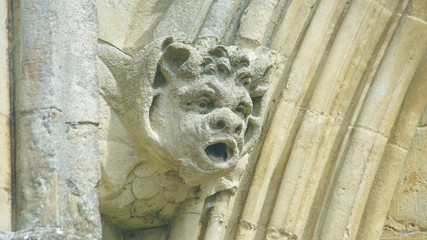 Corbel Head on The West Front of Salisbury Cathedral F, Gargoyle on Early English Gothic Cathedral, shallow depth of field split toning horizontal photography © Jacek Wojnarowski